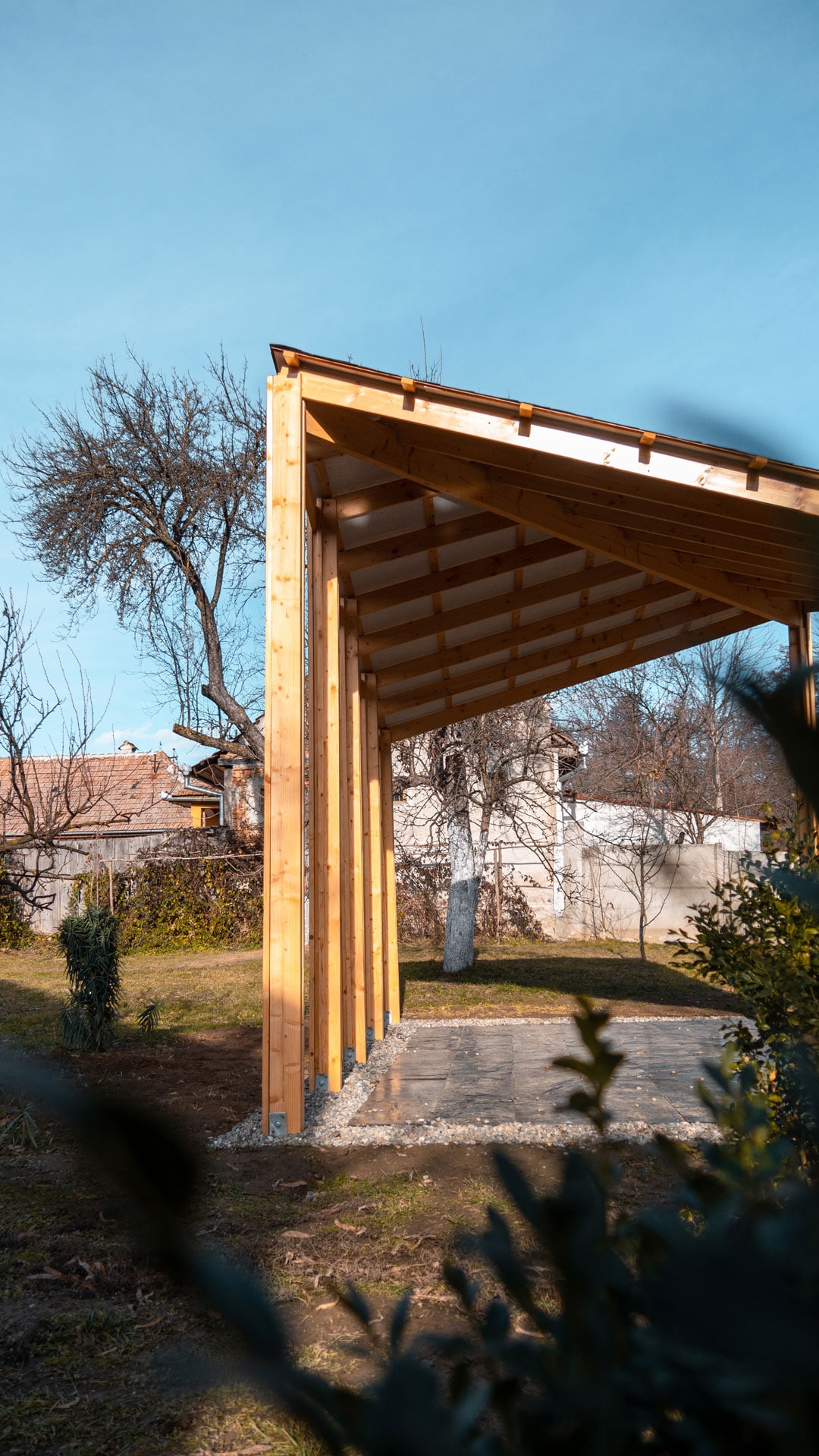 Open evergreen wood lookout, with gravel and varnished slate stone pavement.